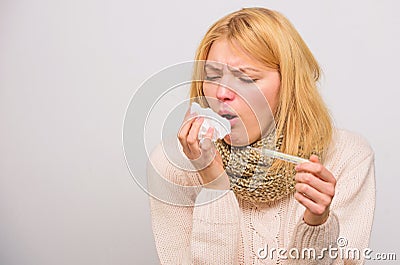 Girl in scarf hold thermometer and tissue close up. Cold and flu remedies. Take temperature and assess symptoms. Measure Stock Photo