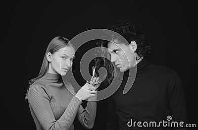 Girl scheming an evil plan of cutting off a curly hair in a man. A smart wily woman has wonderful schemes like a crook Stock Photo