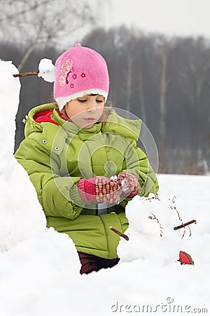 Girl sculpt from snow much snowman Stock Photo