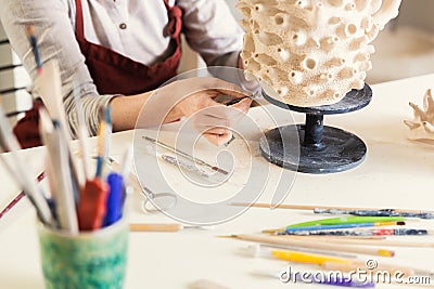 Girl sculptor in the workshop sculpts from clay, close-up Stock Photo