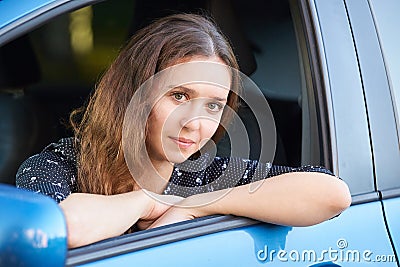 Girl seat at car. Passenger in blue wheel Stock Photo