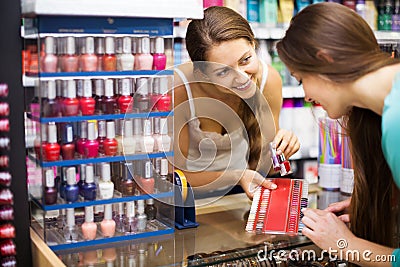 Girl serving purchaser with nail polish Stock Photo