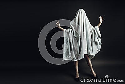 Sexy Girl with long legs in costume Spooky white ghost. Halloween minimal concept Stock Photo