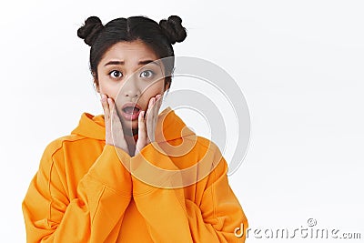 Girl shocked and concerned hear bad news. Emotive worried asian girl listen to upsetting story, feel pity show empathy Stock Photo