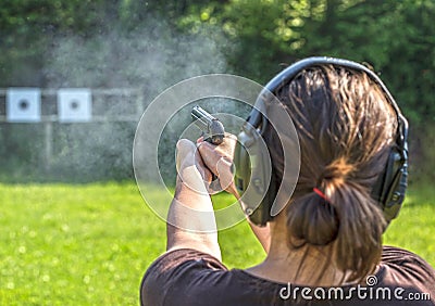 Girl shooting with a gun Stock Photo