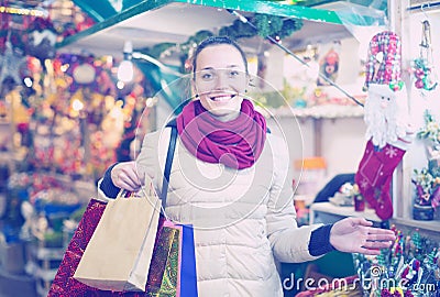 Girl shopping at festive fair before Xmas in evening time Stock Photo