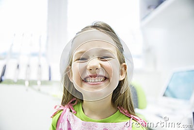 Girl showing her healthy milk teeth at dental office Stock Photo
