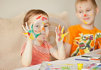 Girl showing painted hands. Hands painted in colorful paints. Education, school, art and painitng concept Stock Photo