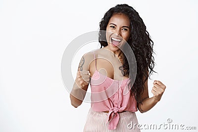 Girl showing whos boss. Successful confident good-looking young female african american with curly hairstyle, tattoos Stock Photo