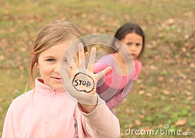 Girl with sign STOP on hand Stock Photo