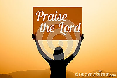 Girl with a sign with word praise the lord Stock Photo