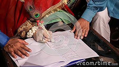 A girl signing on her marriage papers, Marriages in Pakistan, Pakistani marriage papers, Nikkah nama. Stock Photo