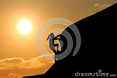 Girl silhouette on top of a mountain climb Stock Photo