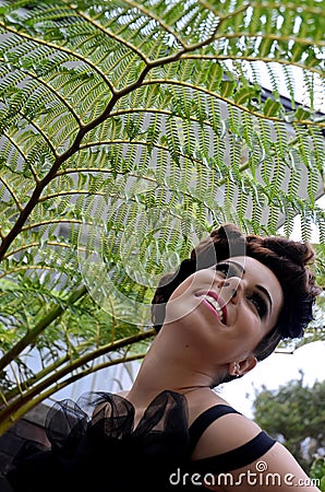 Girl and silver fern Stock Photo