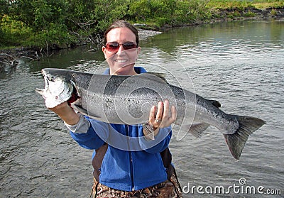 Girl with silver salmon Stock Photo