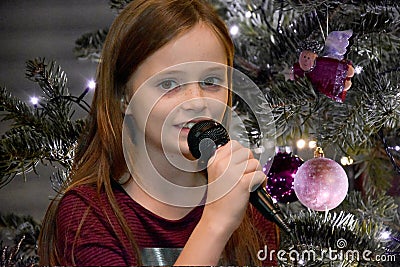 Girl sings christmas songs Stock Photo