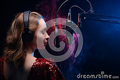 Girl sings into a microphone. Screensaver for a vocal school, work and training in vocals. Singing and lesson in music. Bright Stock Photo