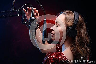 Girl sings into a microphone. Screensaver for a vocal school, work and training in vocals. Singing and lesson in music. Bright Stock Photo