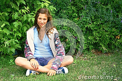 Girl siting in grass Stock Photo