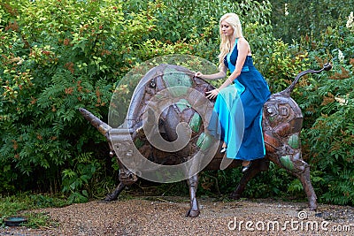 Girl sits on the bull Stock Photo