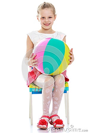 The girl sits on the chair to keep Stock Photo