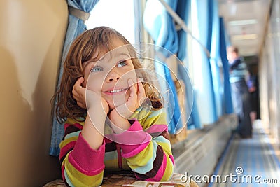 Girl sits in corridor of railway car Stock Photo