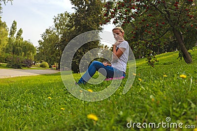 Girl sits in Park on the grass Stock Photo