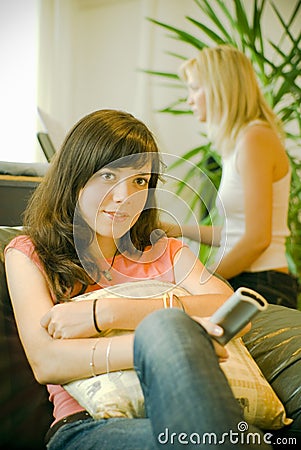 Girl sits watching television Stock Photo