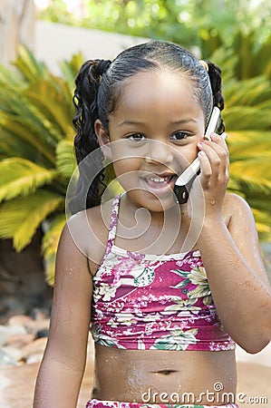 Girl sitting in back yard Using Cell Phone front view Stock Photo