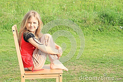 Girl sitting on chair Stock Photo