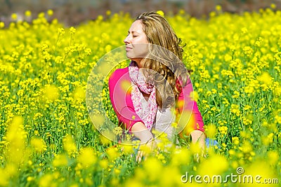 Girl sitting in flowers Stock Photo