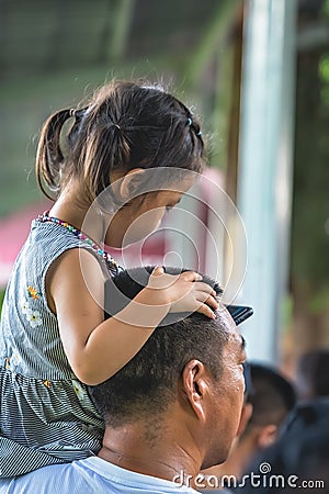 Girl sitting on her father shoulder Editorial Stock Photo