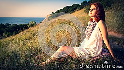 Girl at hill in sunrise. Stock Photo