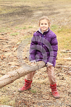 Girl sitting on improvised swing Stock Photo