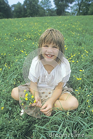 A girl sitting in a meadow of yellow flowers,Homestead, PA Editorial Stock Photo