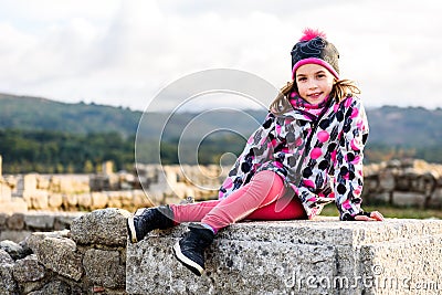 Girl is sitting on remains of ancient roman ruins stone Stock Photo