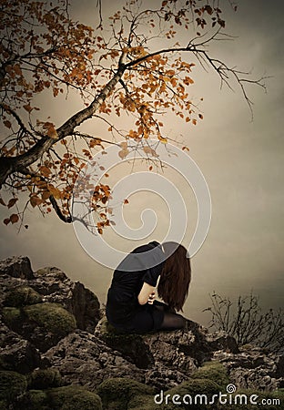 The girl sitting on a rock Stock Photo