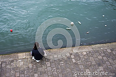 Observing environment trash pollution on the Seine river Paris Editorial Stock Photo