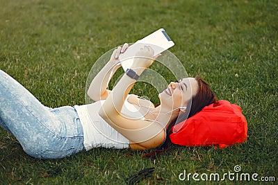 Girl sitting in a university campus use a tablet Stock Photo