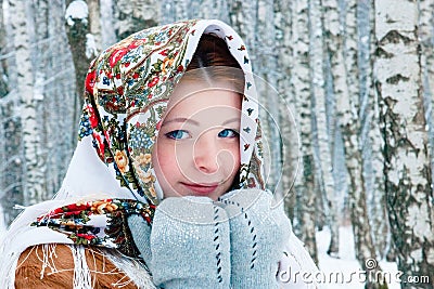 Girl - Slavic appearance smiles. wrapped in a scarf in winter Stock Photo