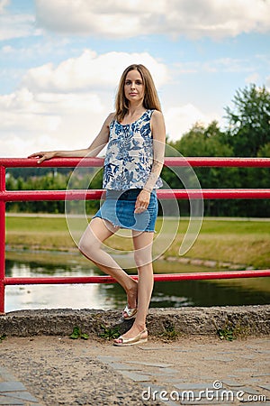 Girl in blouse and skirt having rest at country recreation area, enjoying fresh air and calmness Stock Photo