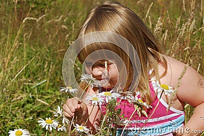 Girl smelling flowers Stock Photo