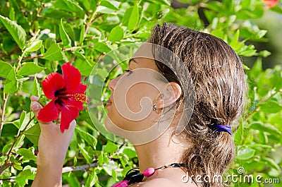 Girl smells an exotic flower Stock Photo