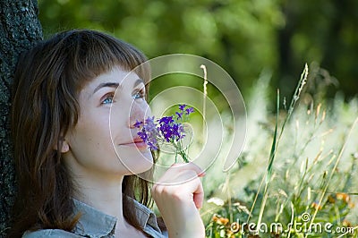Girl smells a flowers Stock Photo