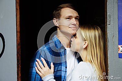 Girl smiles.Close-up of kissing and embracing couples in old, doorway, family. date, attraction. family happiness Stock Photo