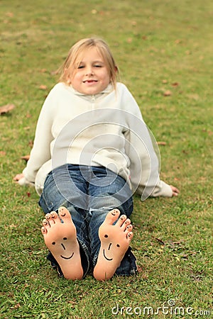 Girl with smileys on toes and soles Stock Photo