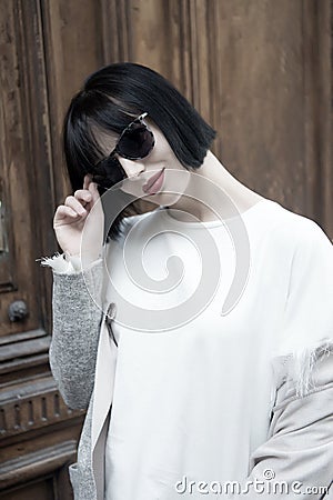 Girl smiling in fashionable glasses and shirt. Stock Photo