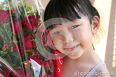 Girl smiling & holding bouquet of roses Stock Photo