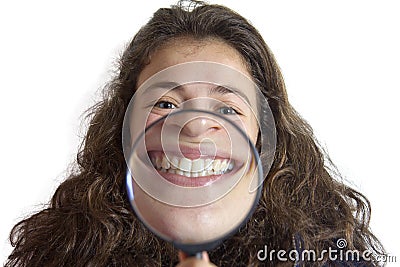 Girl smiling and show teeth through a magnifying glass Stock Photo