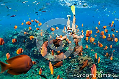 Girl in snorkeling mask dive underwater with coral reef fishes Stock Photo